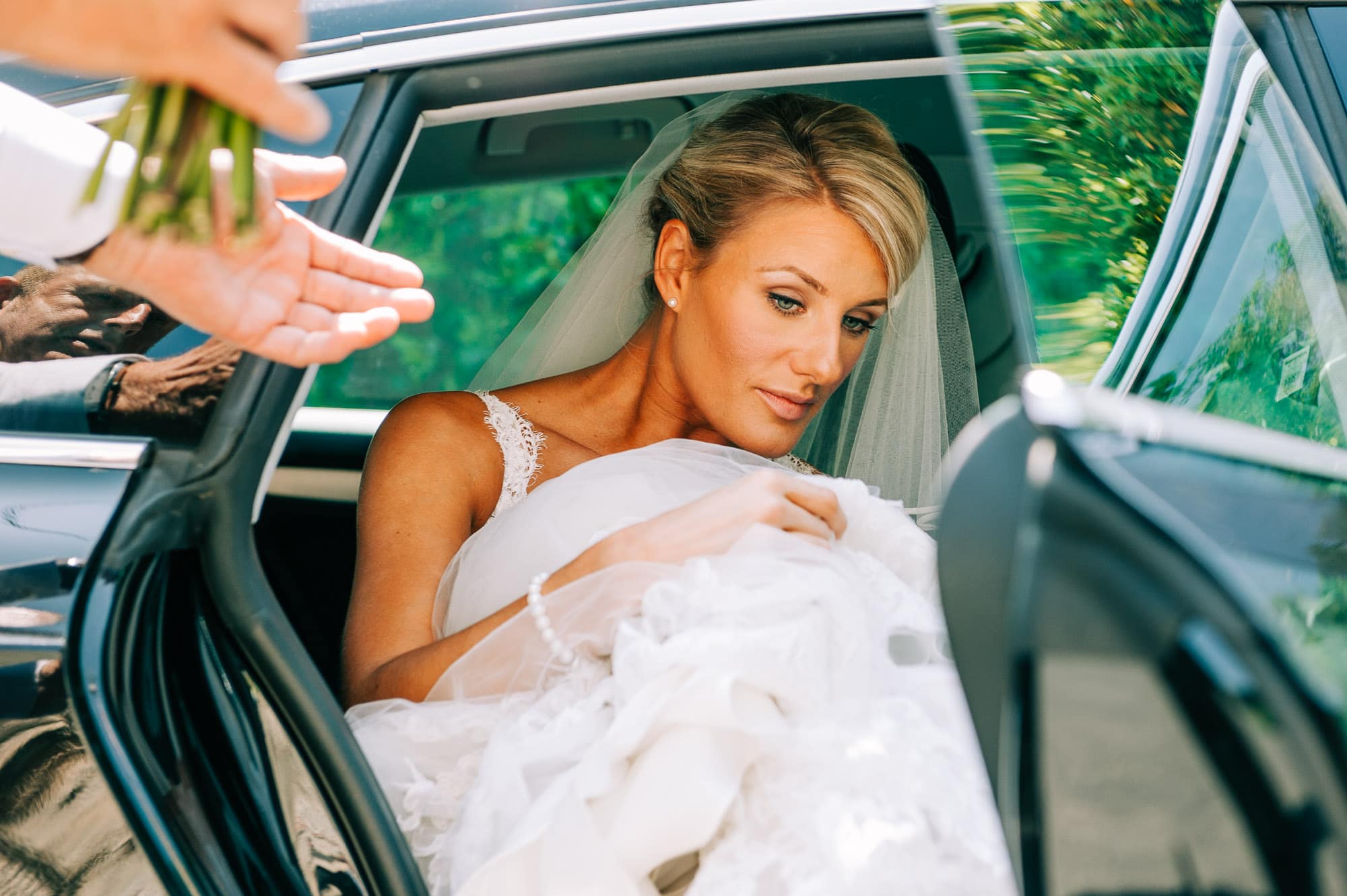 Bride getting out of her wedding car