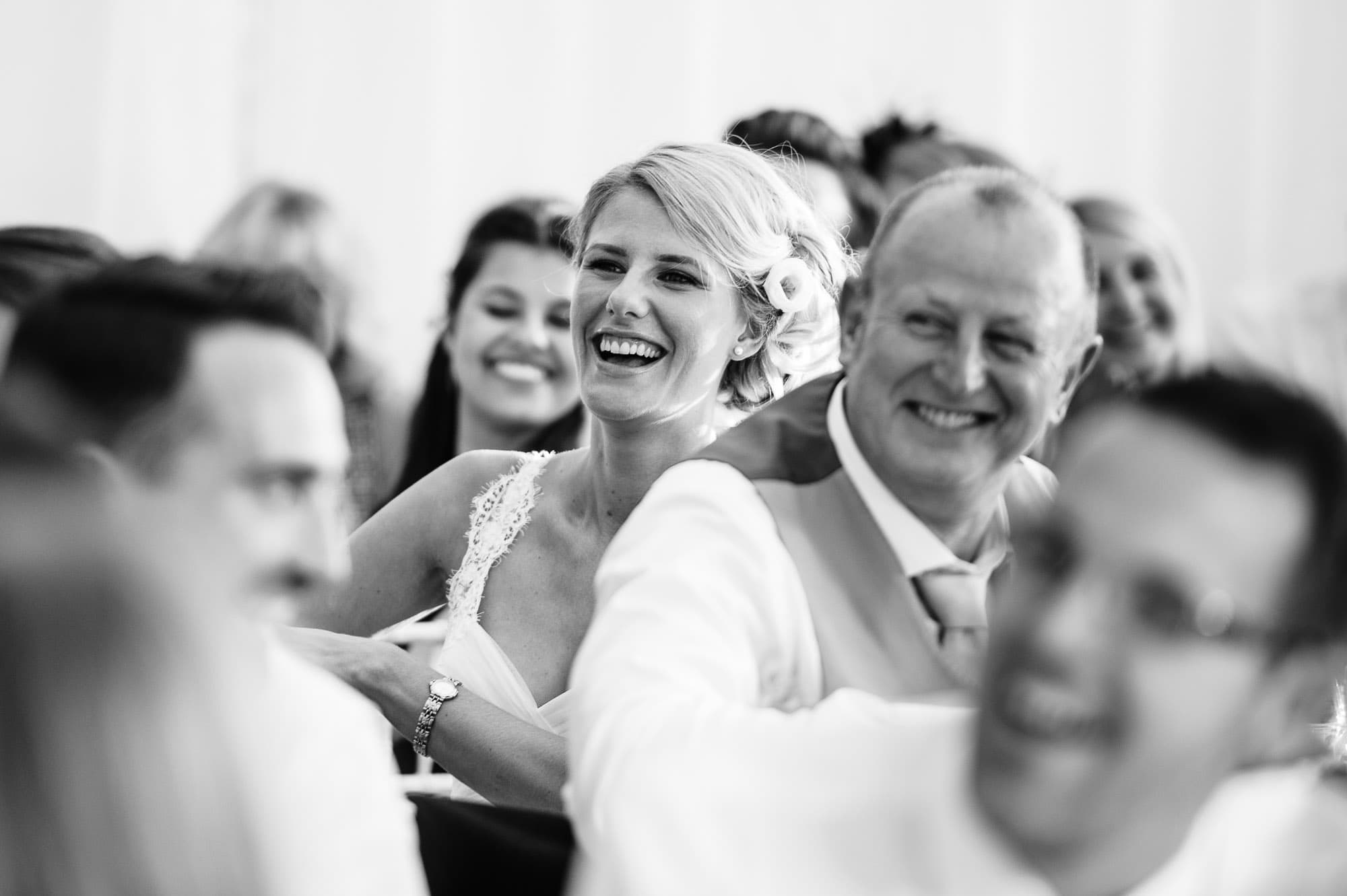 Bride laughing during the speeches