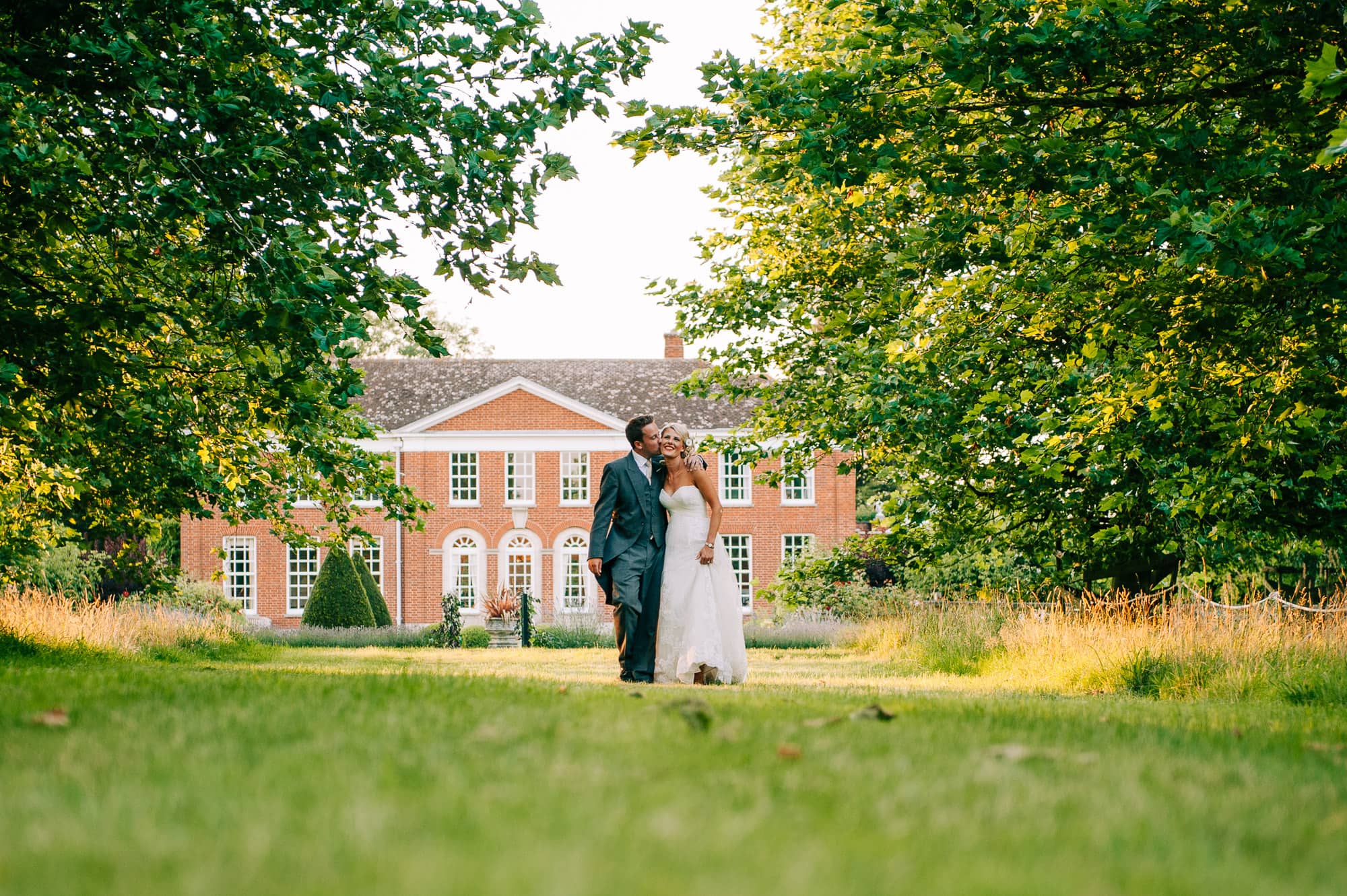 Bride and groom walking in front of Hockering House
