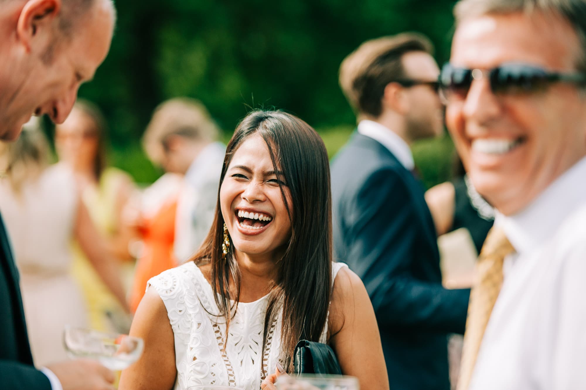 Wedding guest laughing during the drinks reception