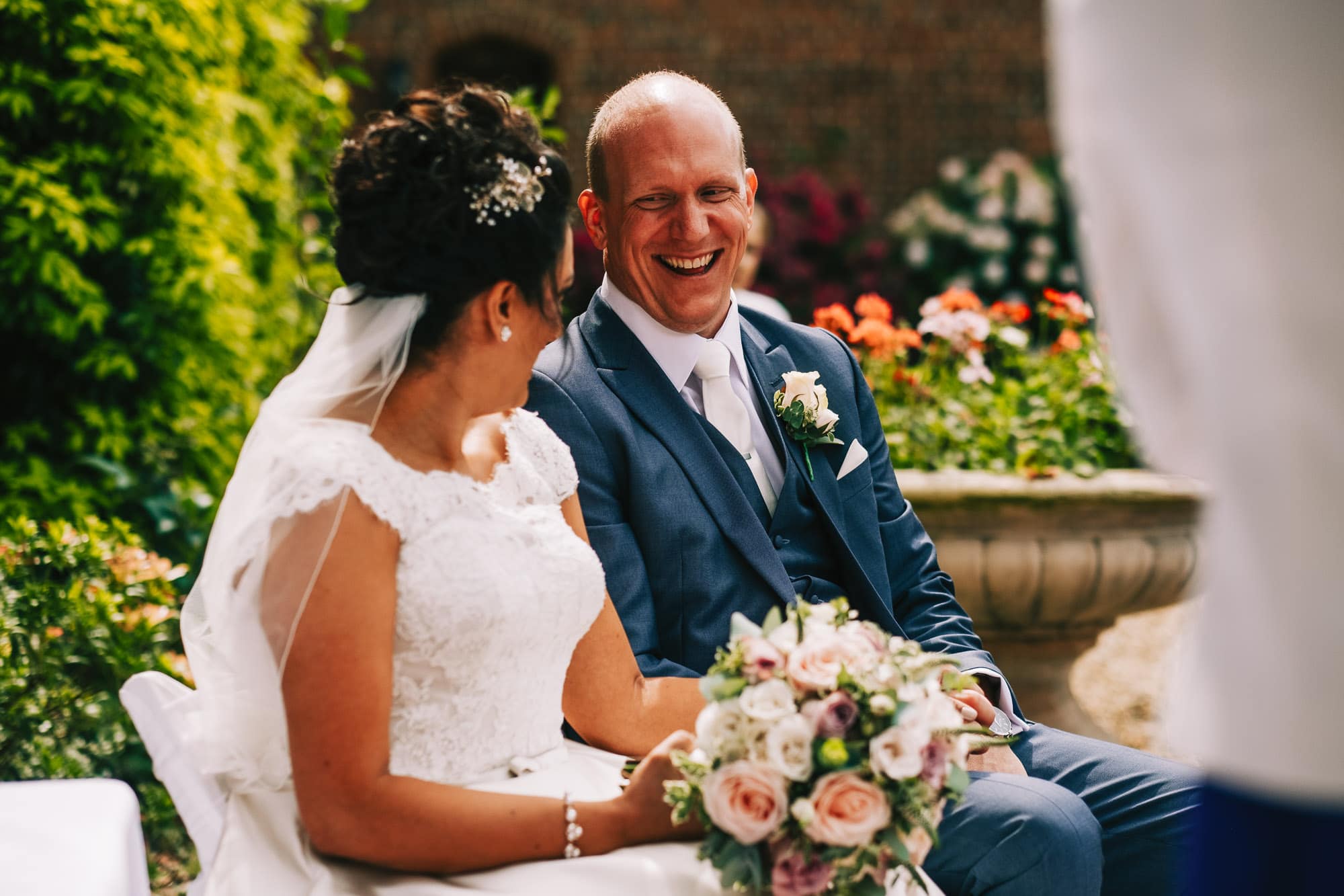 Groom laughing during the ceremony