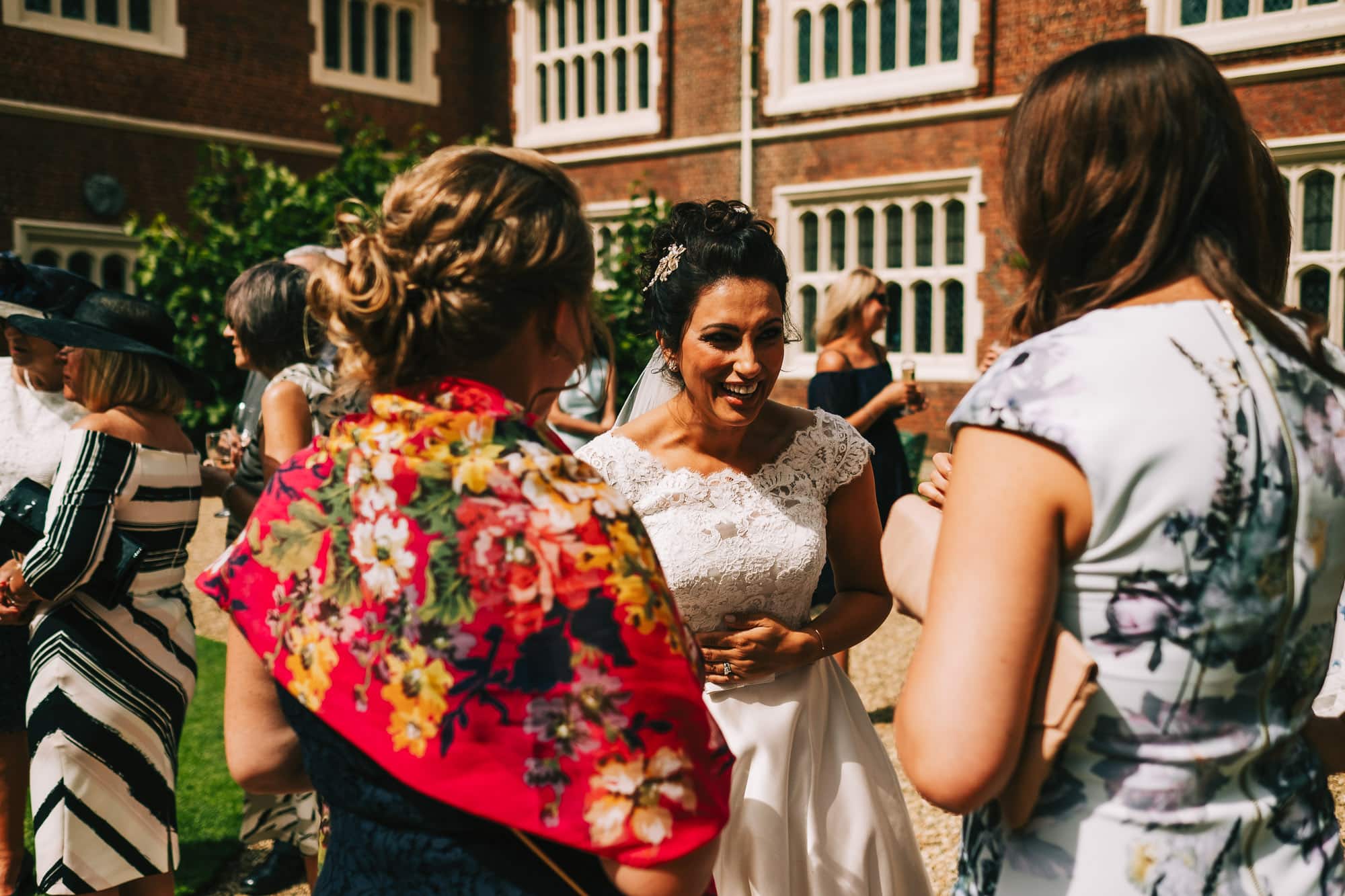 Bride laughing with guests