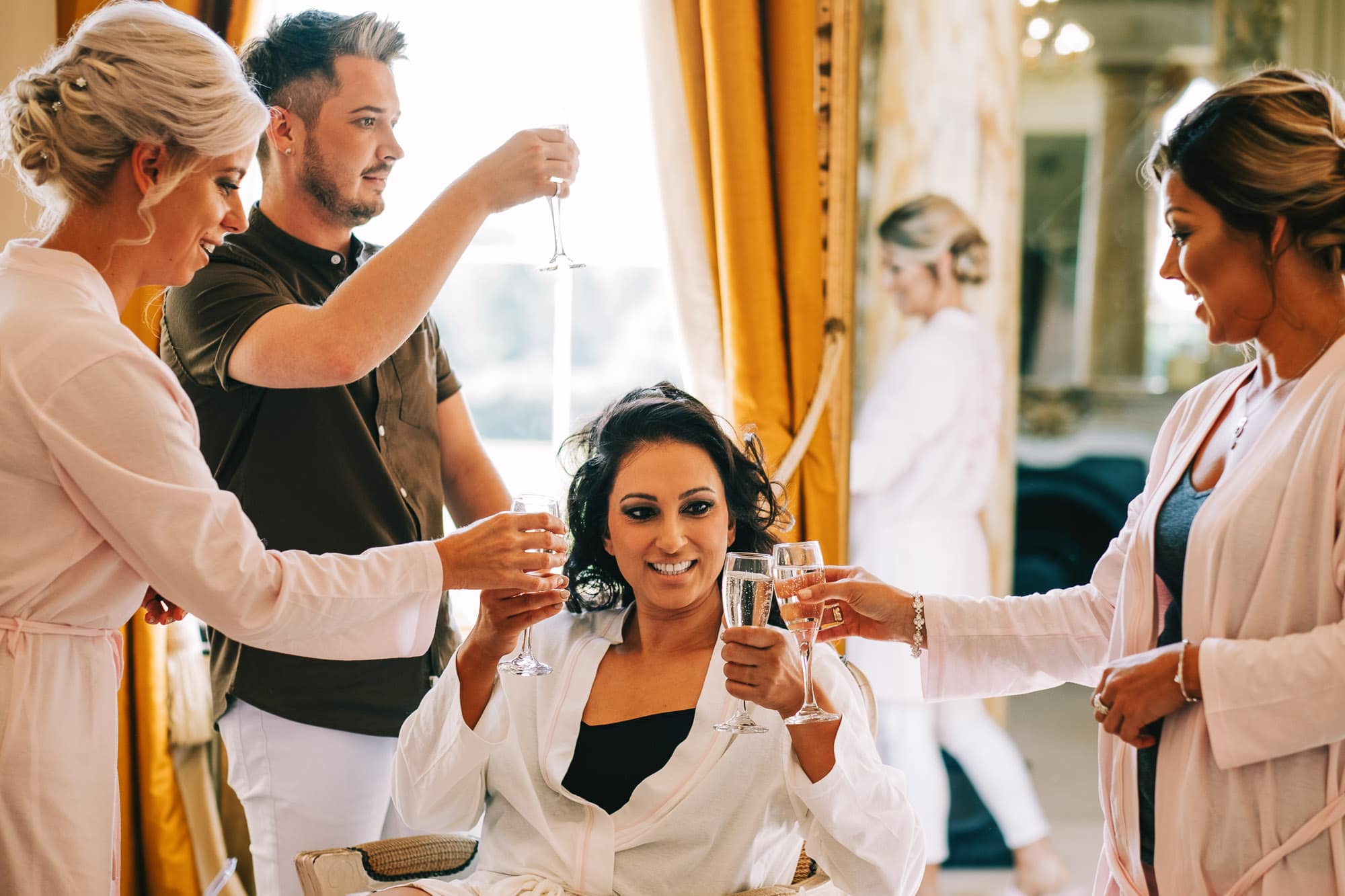 Bride and bridesmaids make a toast with prosecco