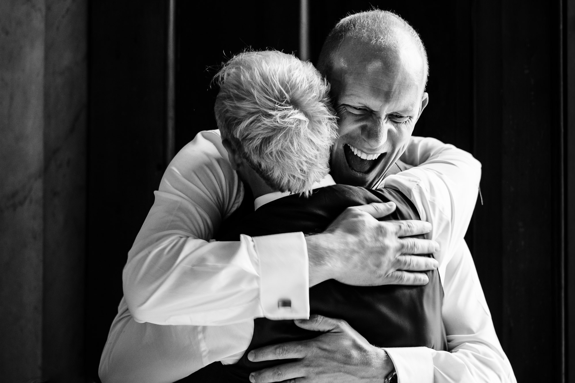 Groom hugging his bestman