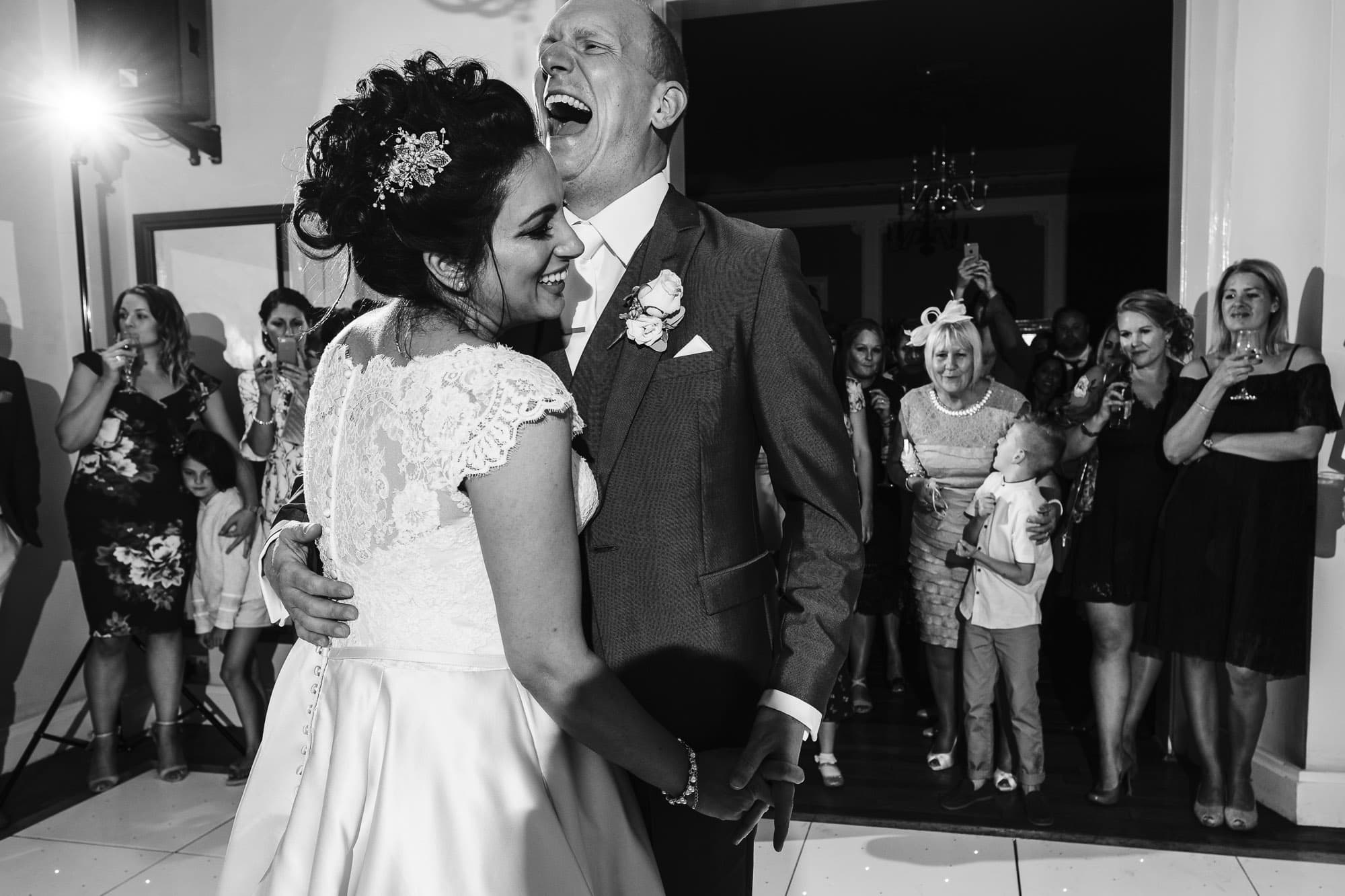 Grooms laughs during their first dance