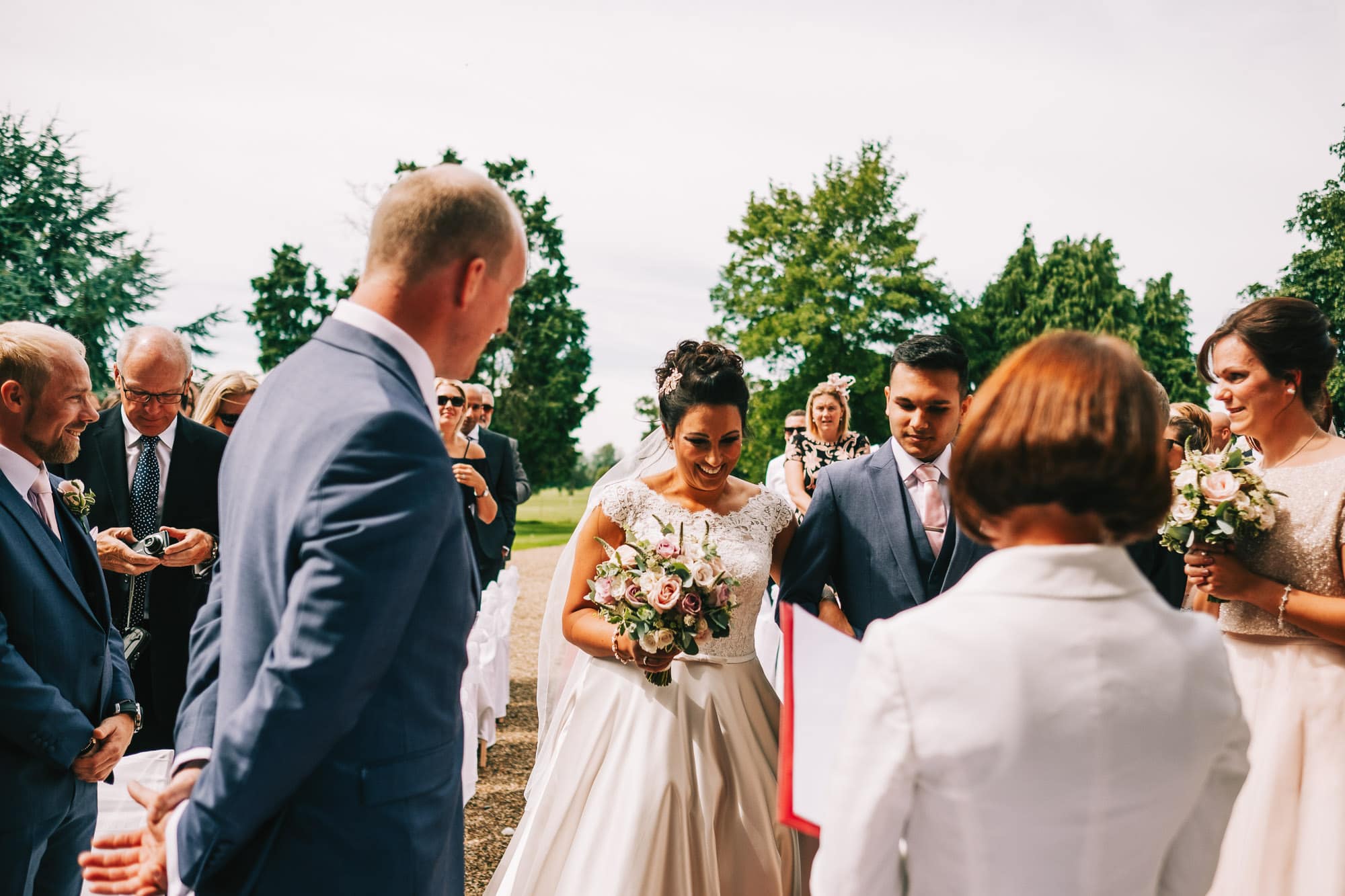 Bride meets the groom at the end of the aisle