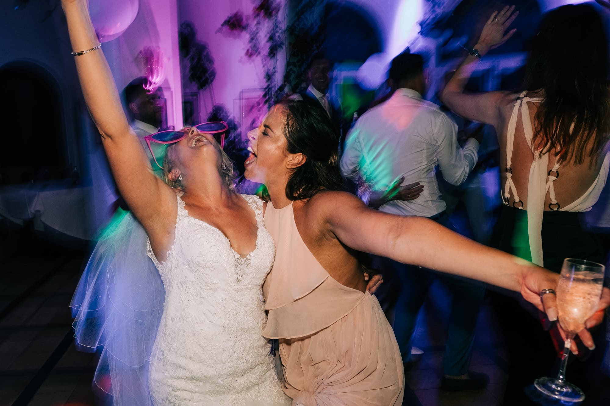 Bride and bridesmaid dancing at Villa Eva