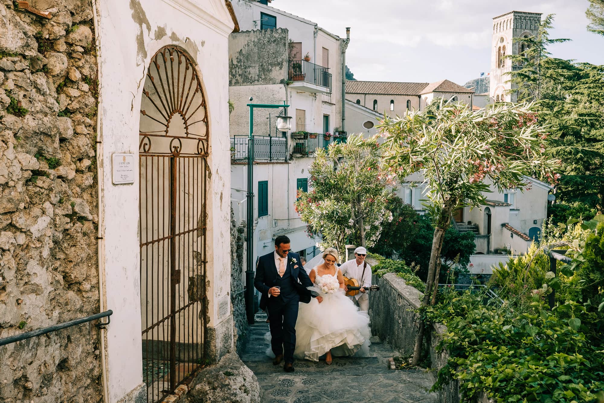 Bride and groom climbing the steps to Villa Eva