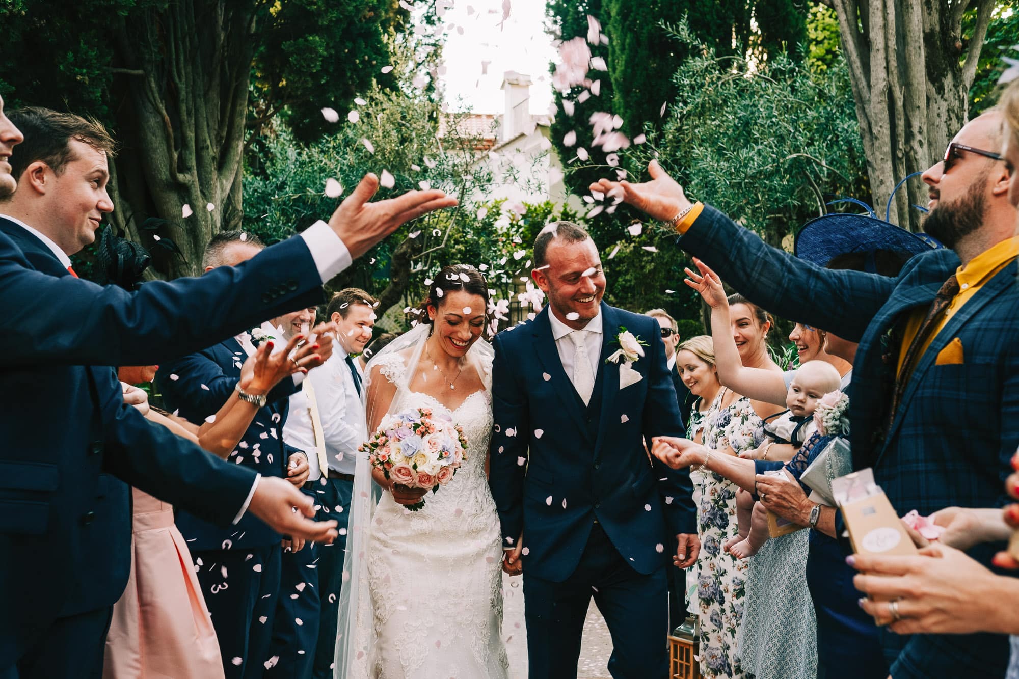 Bride and groom getting covered in confetti at Villa Eva