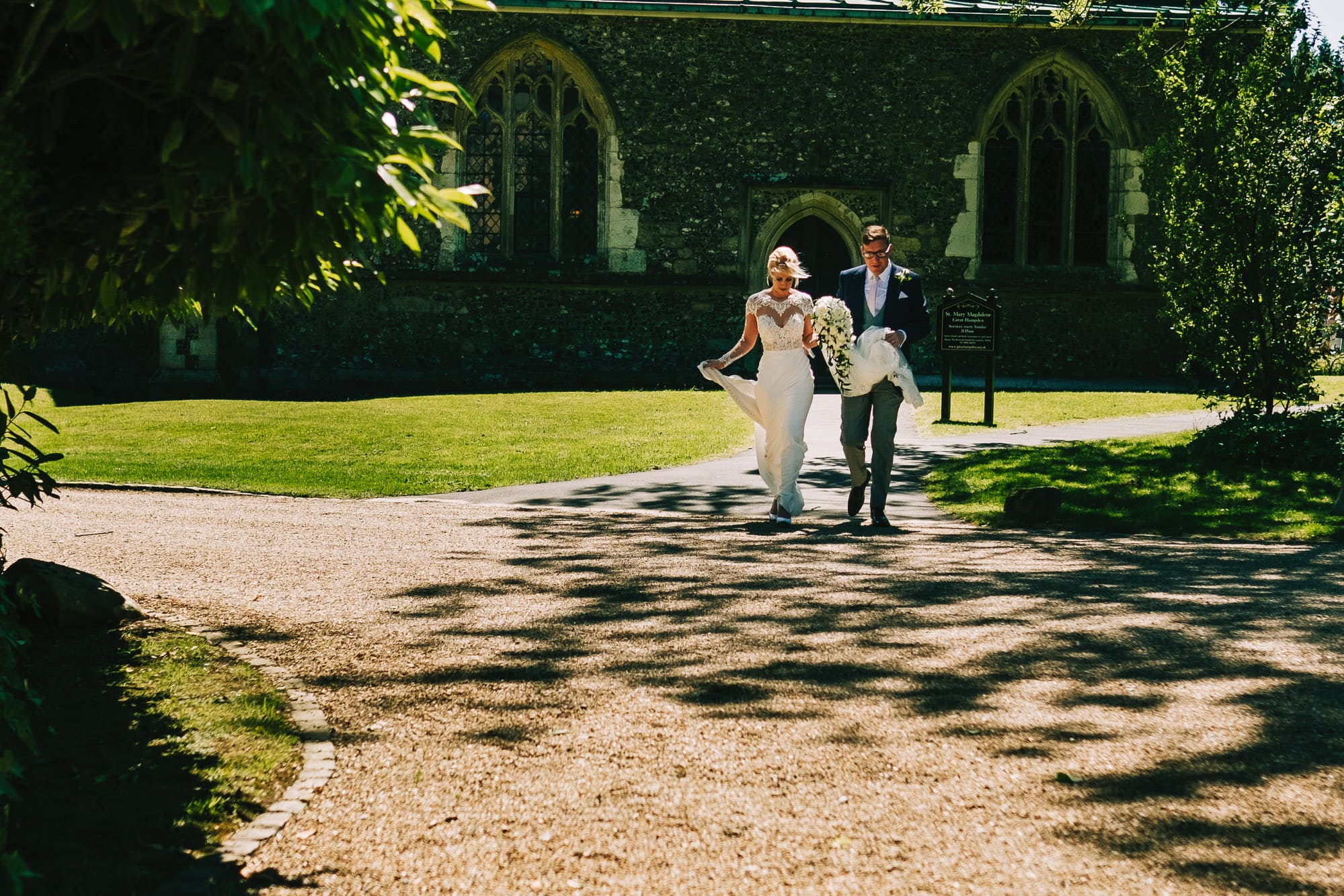 Bride and groom leave the church and walk to Hampden House