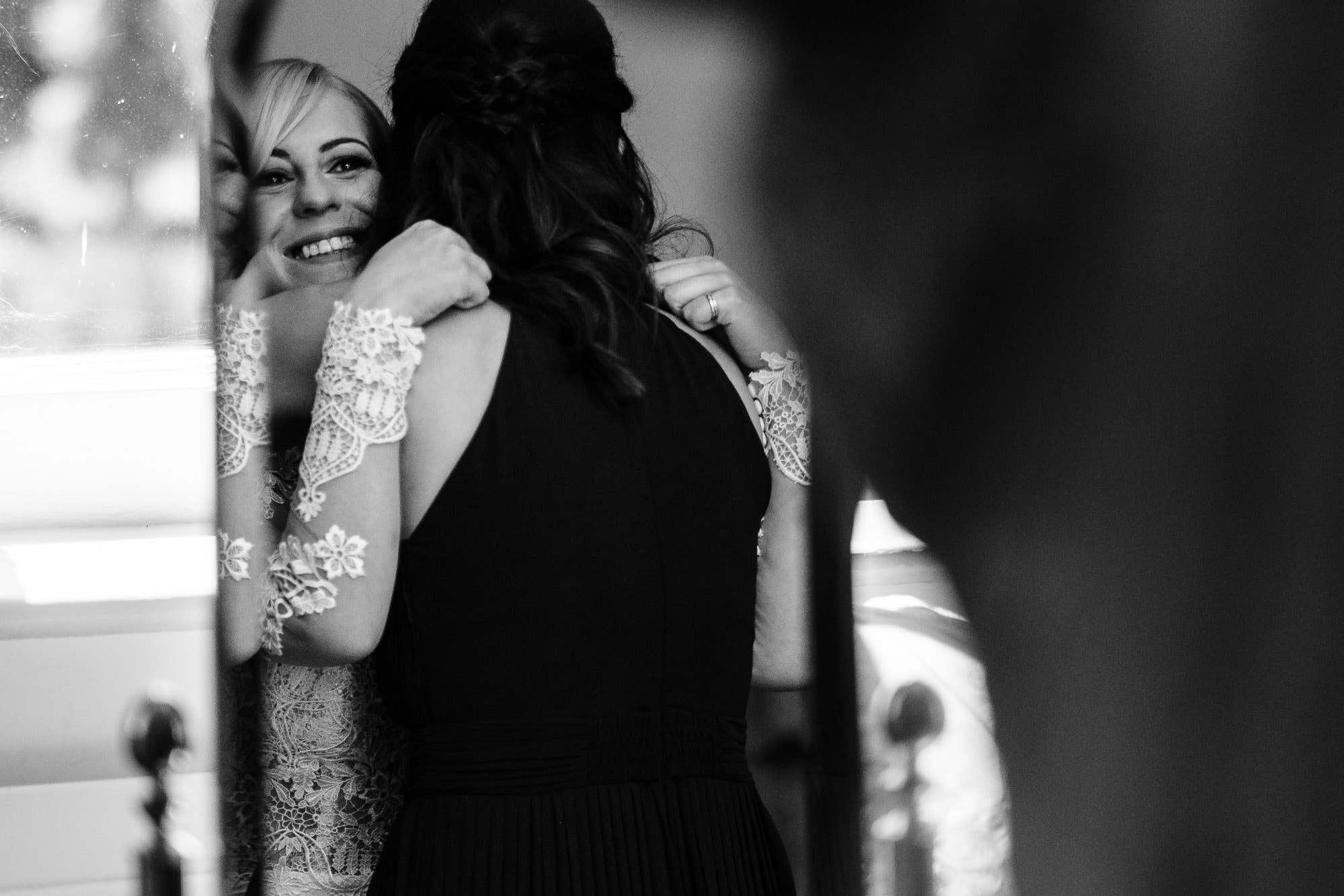 Bride hugs her bridesmaid