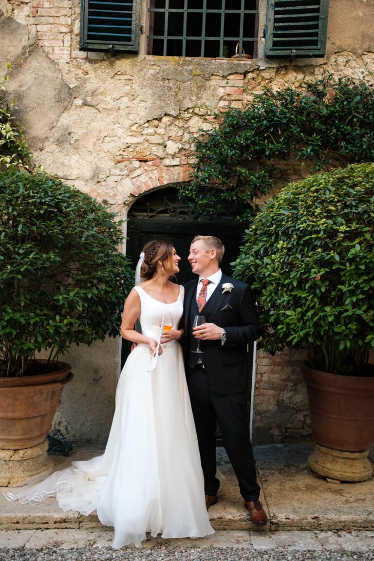 Bride and groom looking at each other with a Aperol Spritz