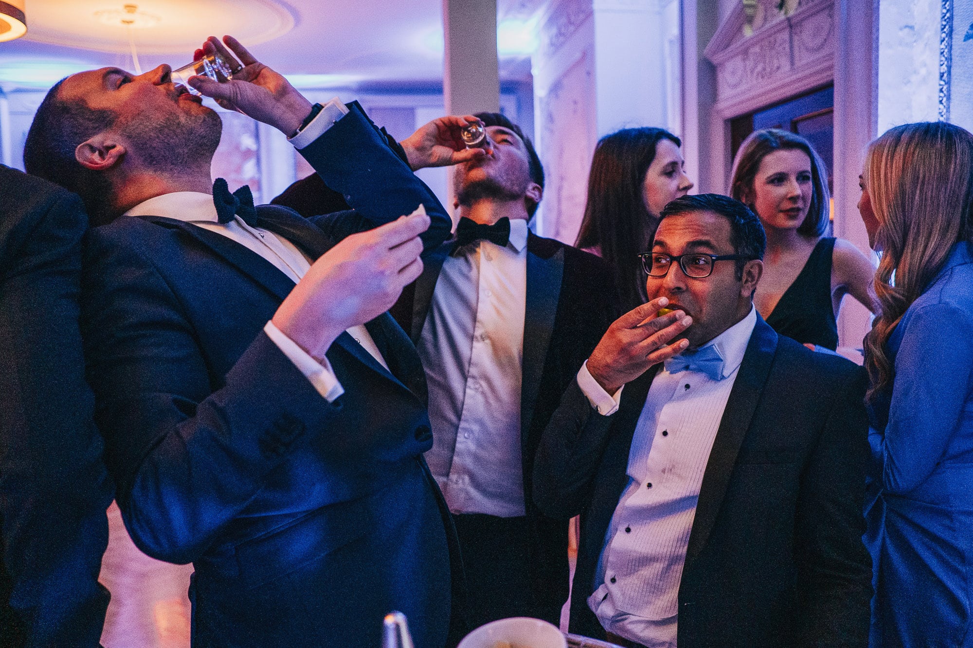 Wedding guests drinking shots at Brown's Hotel in London