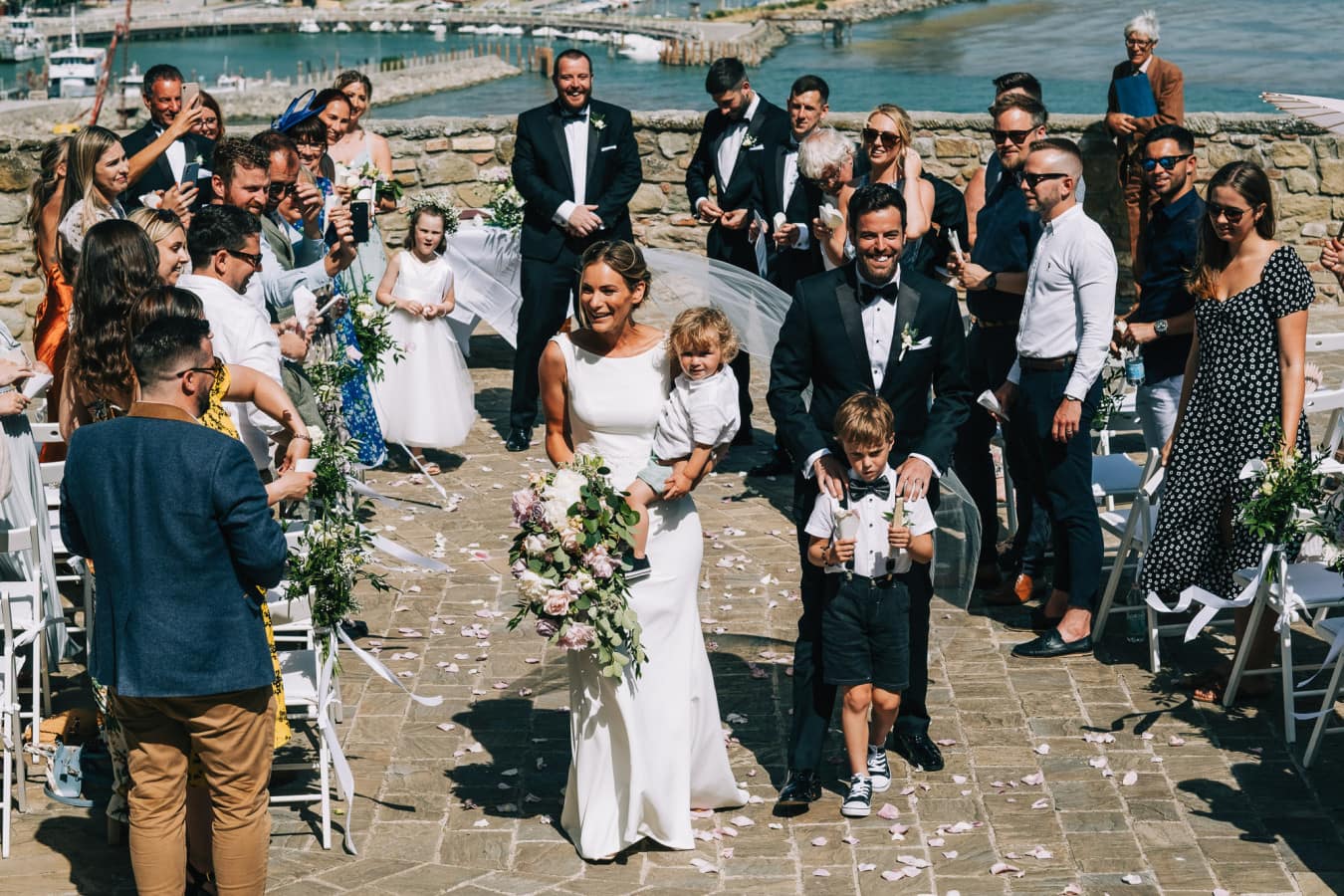Bride and groom smiling at the end of the aisle