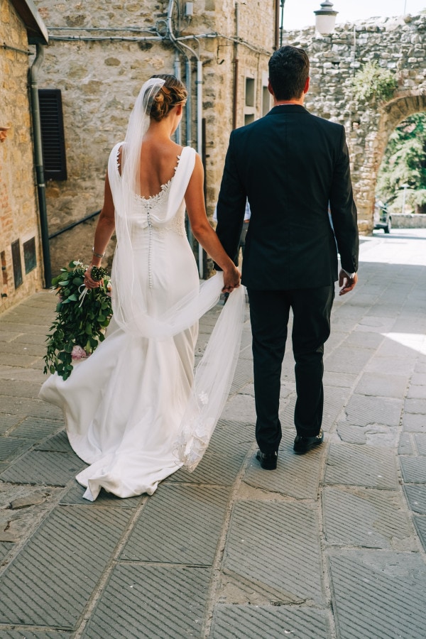 Bride and groom walking holding hands