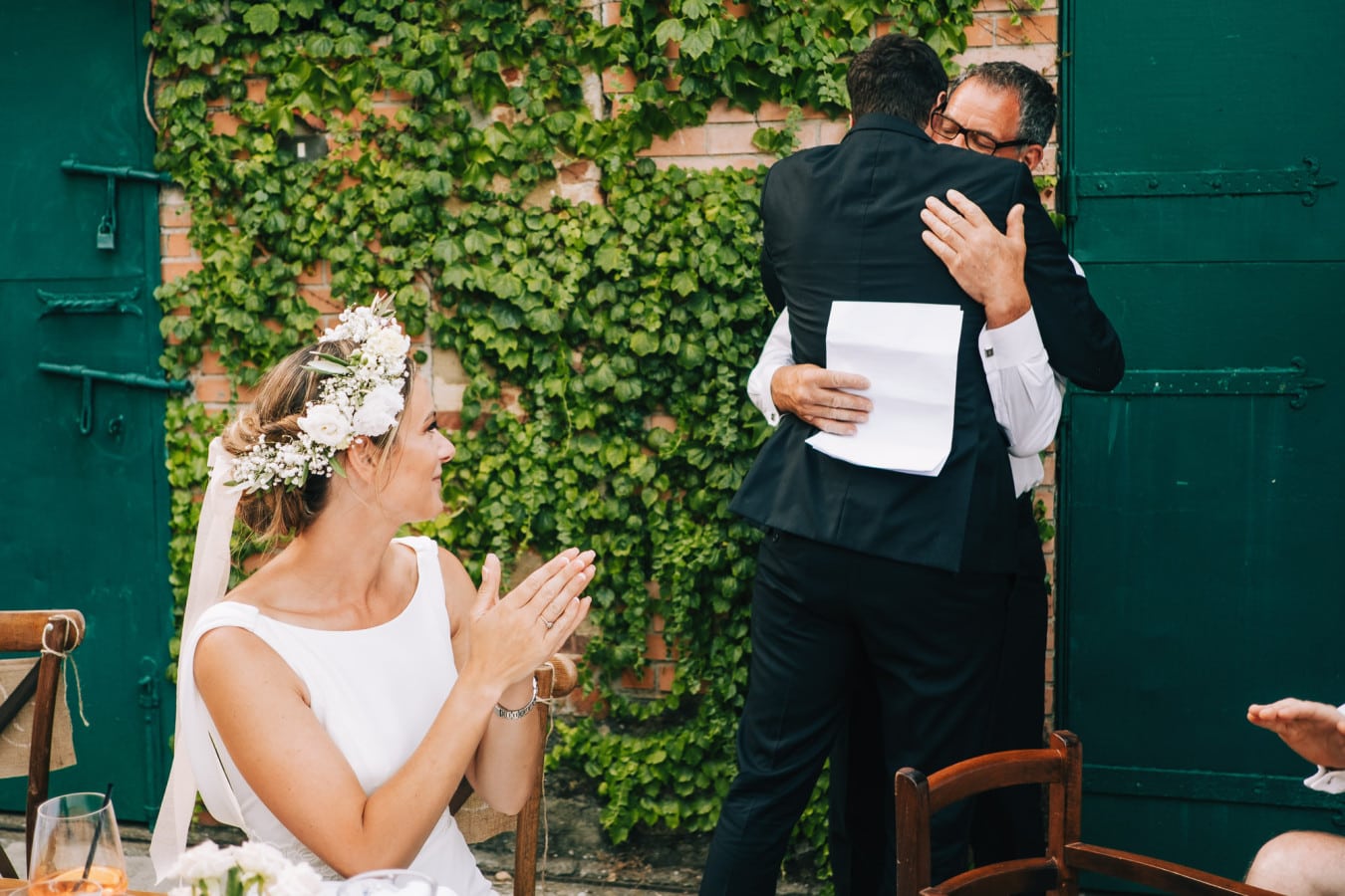 Groom hugs the father of the bride