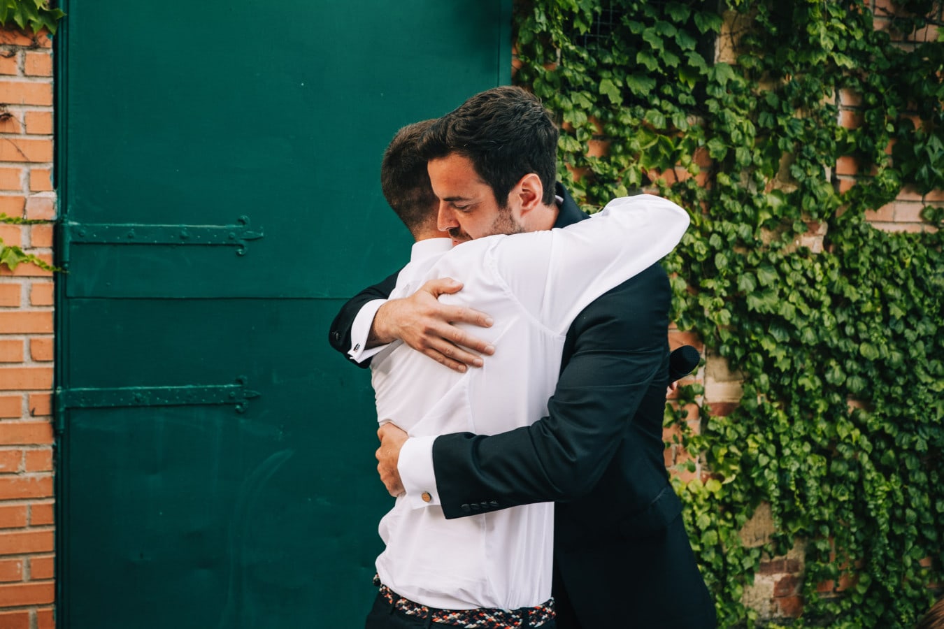 Groom hugging his best man