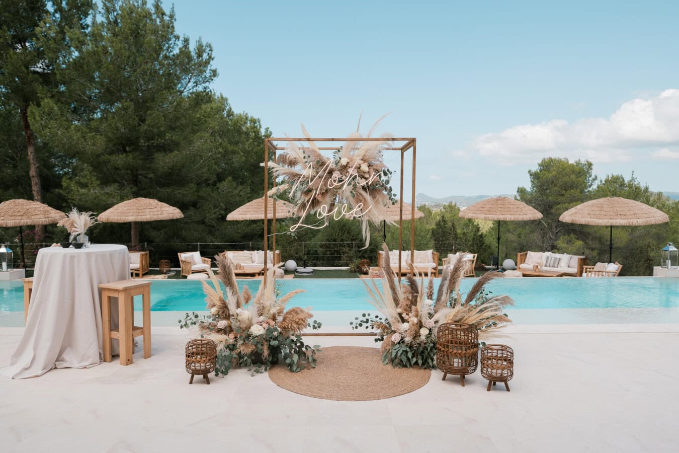 Wedding ceremony setup in front of a pool in a private villa in Spain