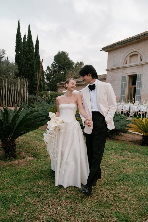 Bride and groom walking in the gardens at Fontsanta Hotel