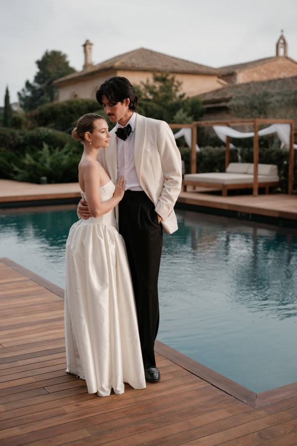 Bride and groom standing by the poolside at Fontsanta Hotel