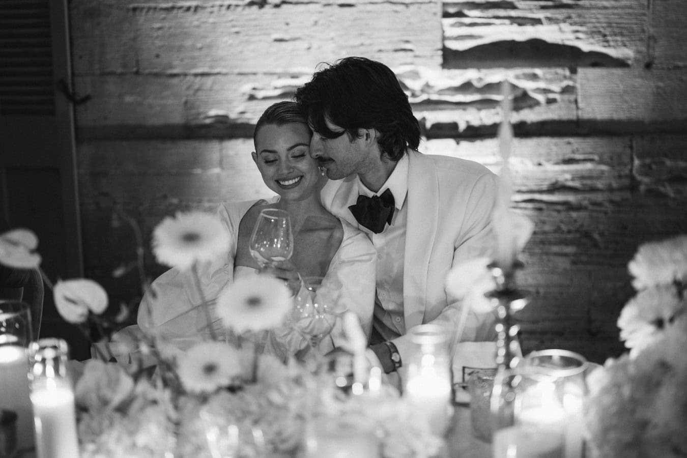 Bride and groom snuggling up together during the evening dinner